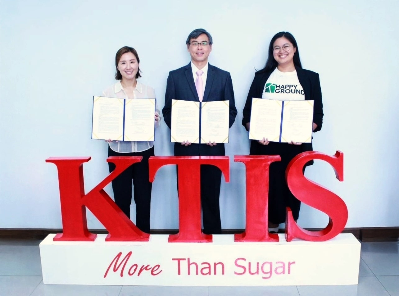 Signing ceremony with representatives from KTIS, CnerG, and Happy Ground holding agreements